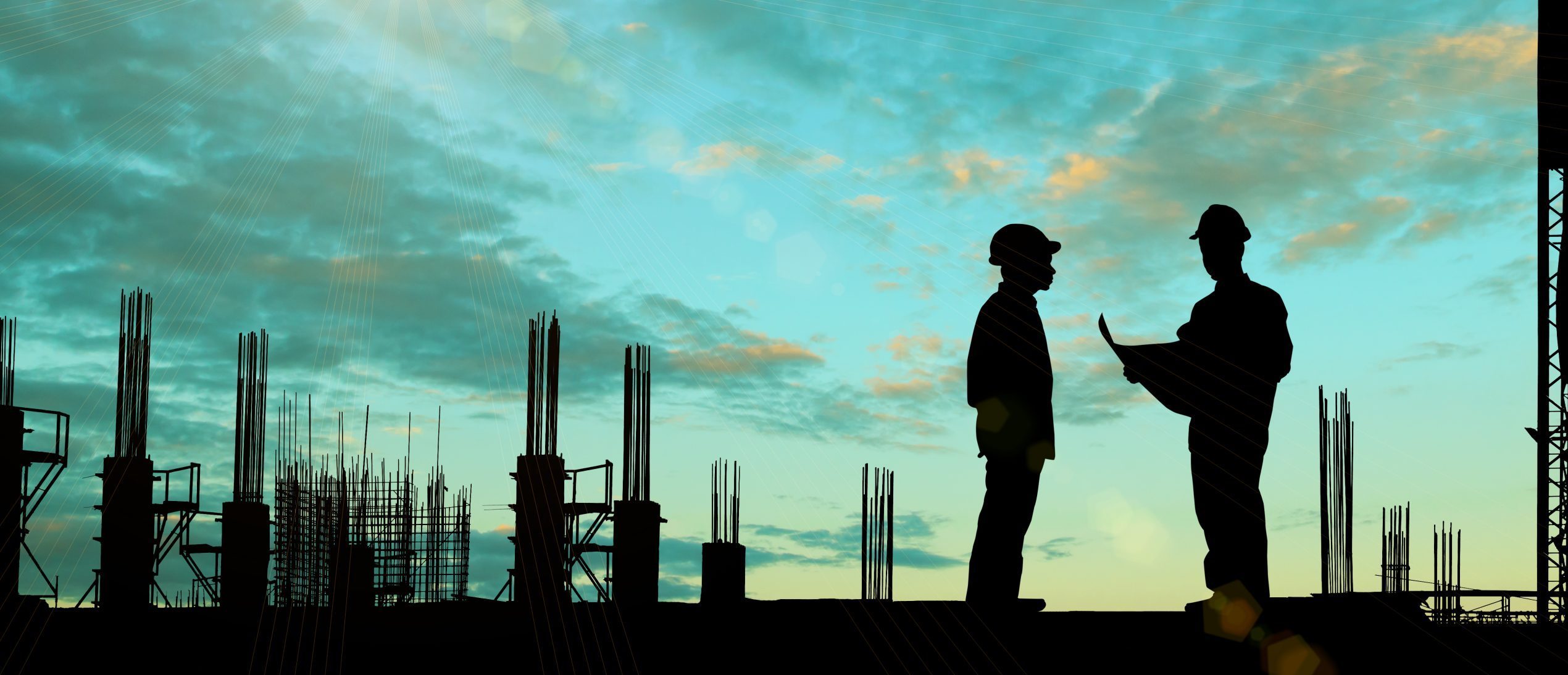A silhouette image of construction site and 2 men