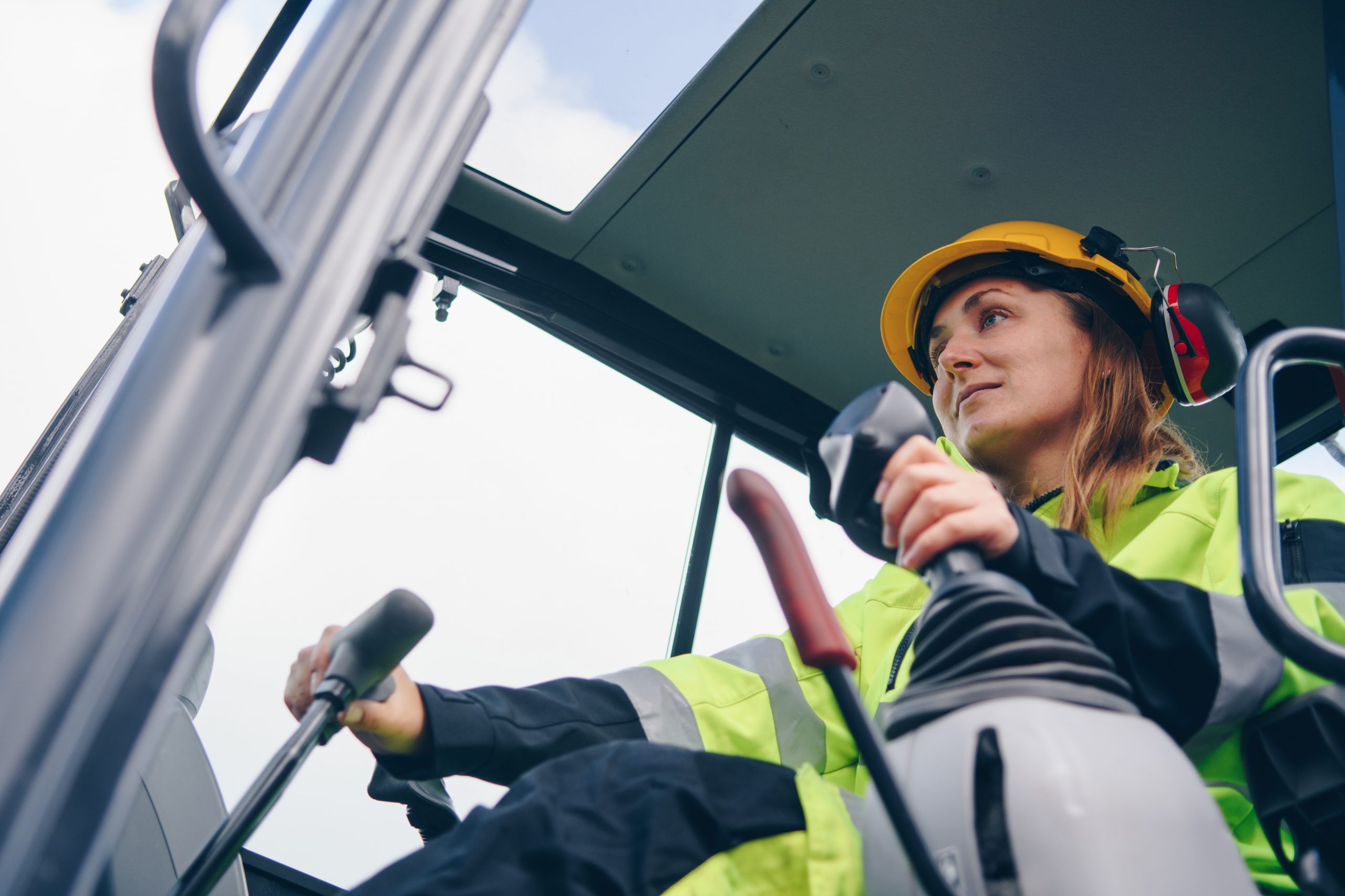 An image of a woman driving heavy equipment