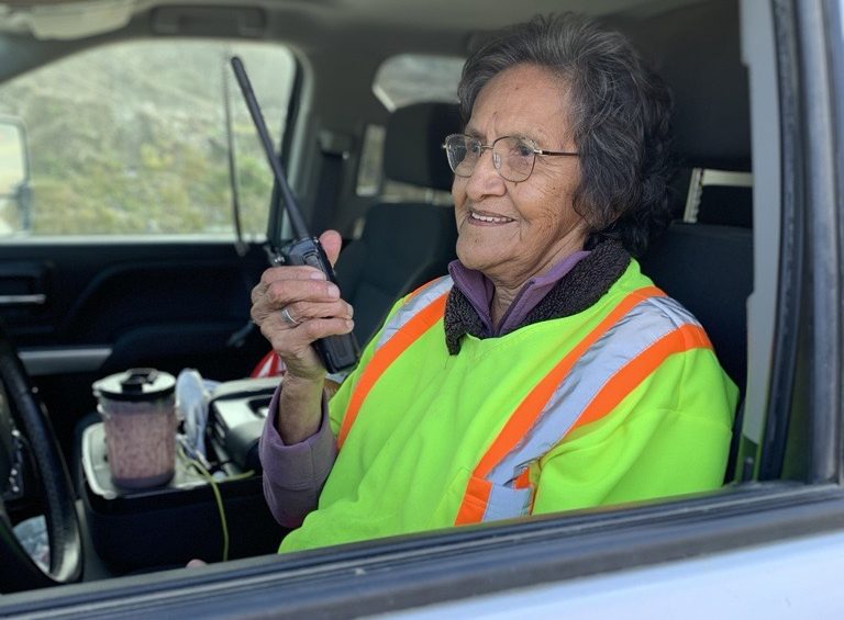 An image of a BCIB employee named Doreen holding a walkie talkie